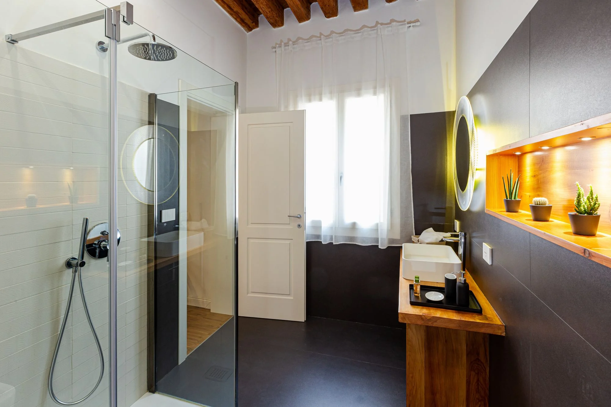 Rain shower and vanity with round mirror