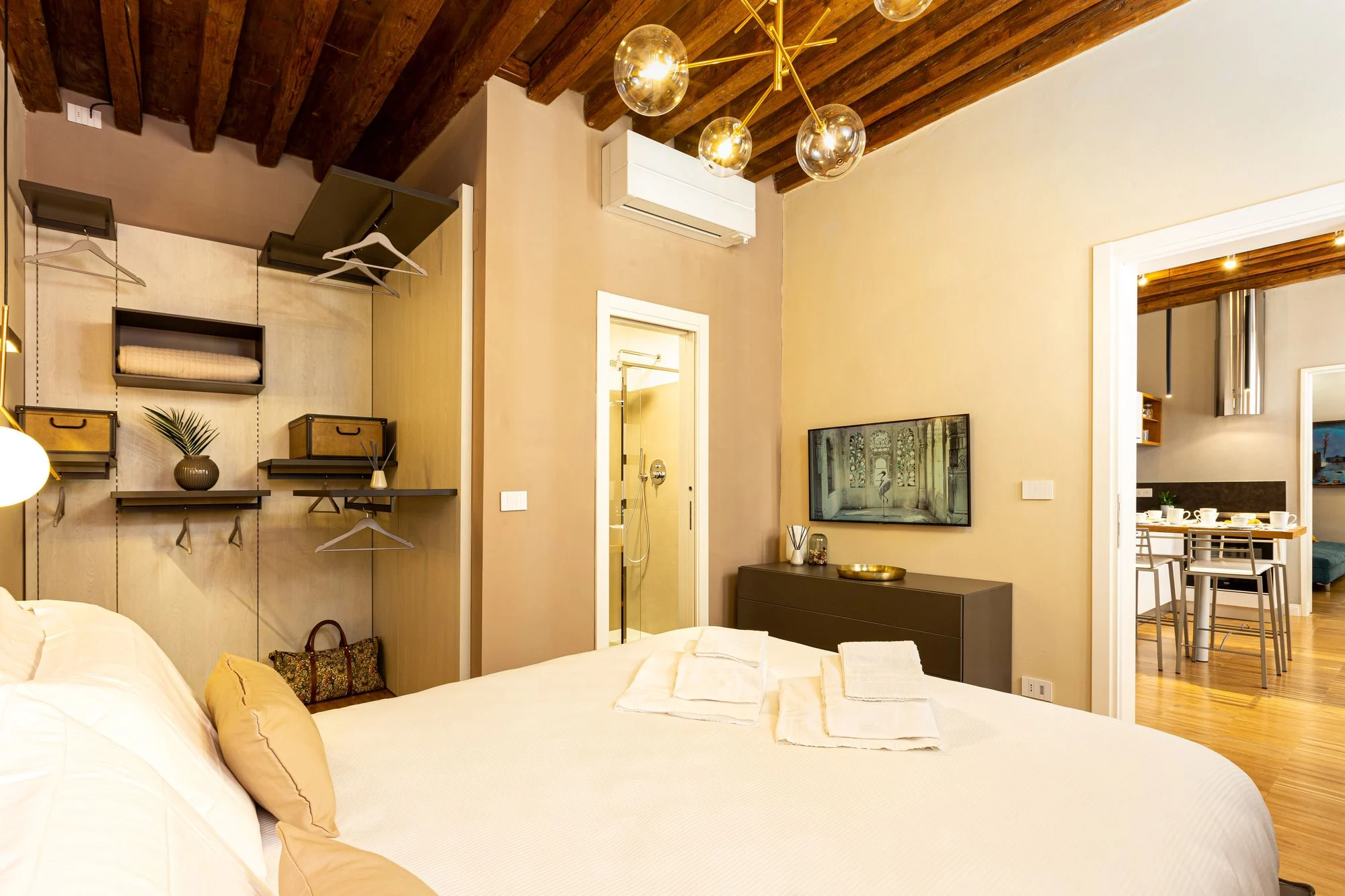 Open wardrobe and bed in the first bedroom